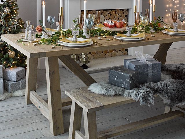 festive scandi inspired table setting decor with grey faux and large oak dining table in a dining room