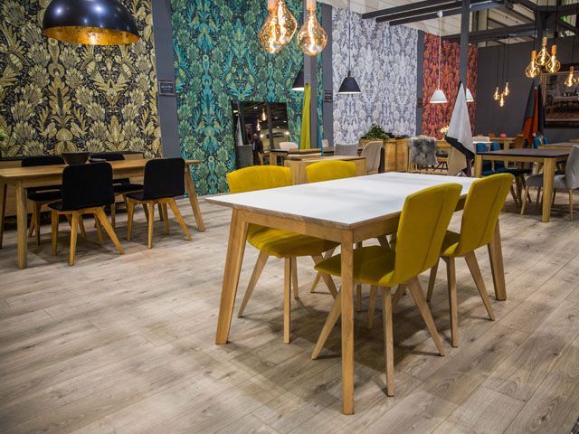 lighting stand exhibitor with colourful wallpaper, modern lighting and various tables and chairs at grand designs live 2017