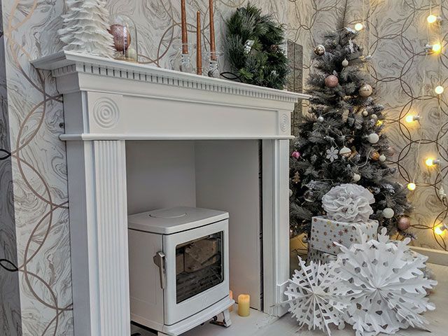a white stove in a fireplace by ACR stoves at the good homes roomsets at ideal home show Christmas 2018 - roomsets - goodhomesmagazine.com