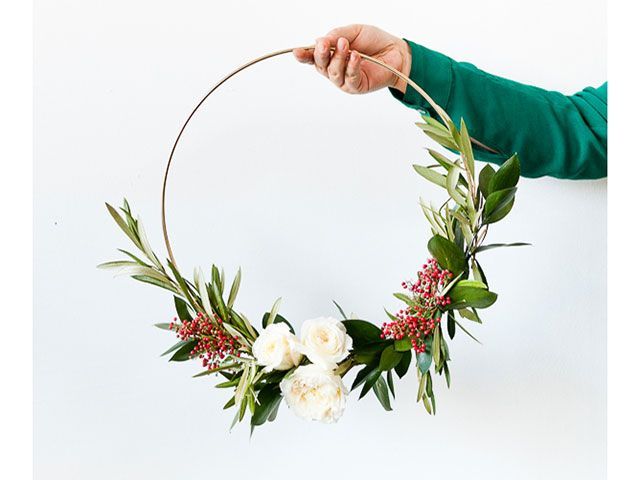 modern asymmetrical christmas wreath held up by papernstitch from pinterest - pinterest boards to follow - living room - goodhomesmagazine.com