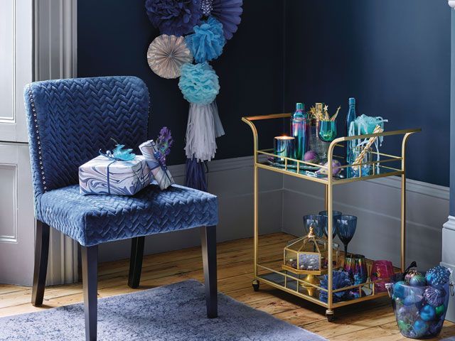 Blue pompoms with gold barcart and blue accessories from Homesense