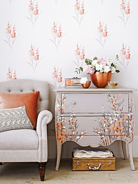 A living room with a French-style chest of drawers which have been upcycled with grey paint and a beautiful floral design in white and peach