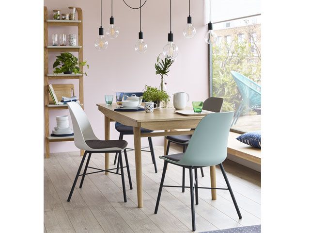 Dining room with hanging light pendant and flowers on dining table -living-room-goodhomesmagazine.com