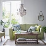 Green sofa in botanical themed living room -m-s-living-room-goodhomesmagazine.com