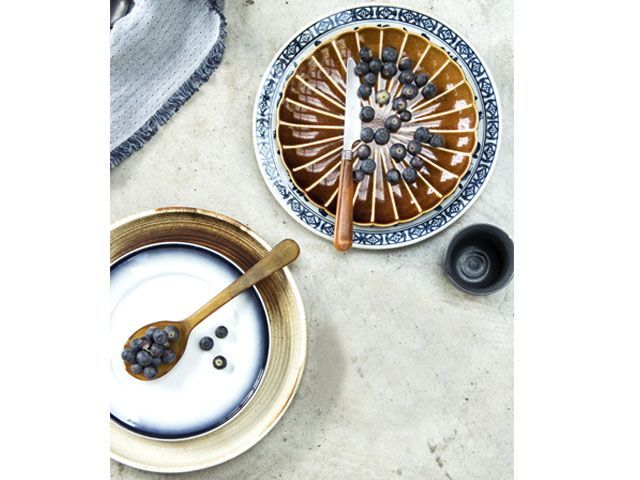 Retro-style blue and brown plates with blueberries placed on top of them -trouva-living-room-goodhomesmagazine.com