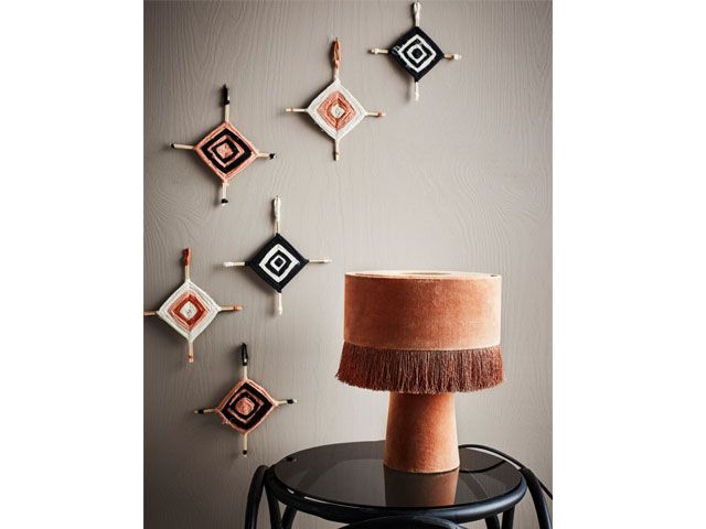 Velvet orange lamp with tassels on a black side table trouva-living-room-goodhomesmagazine.com