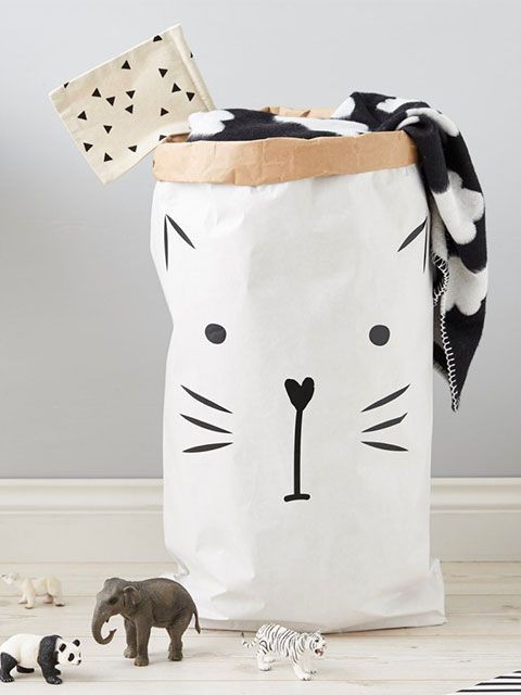 Black and white laundry bag with an illustrated cat face on the front