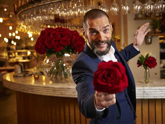 Fred Sirieix in First Date's resturant holding a rose