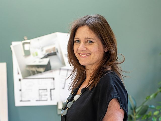 Interior stylist Pippa Jameson standing in her office