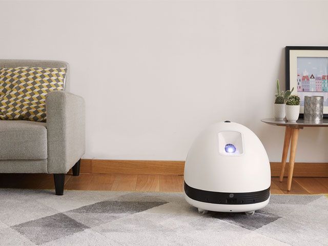White Keecker robot placed in a living room -keecker-living-room-goodhomesmagazine.com