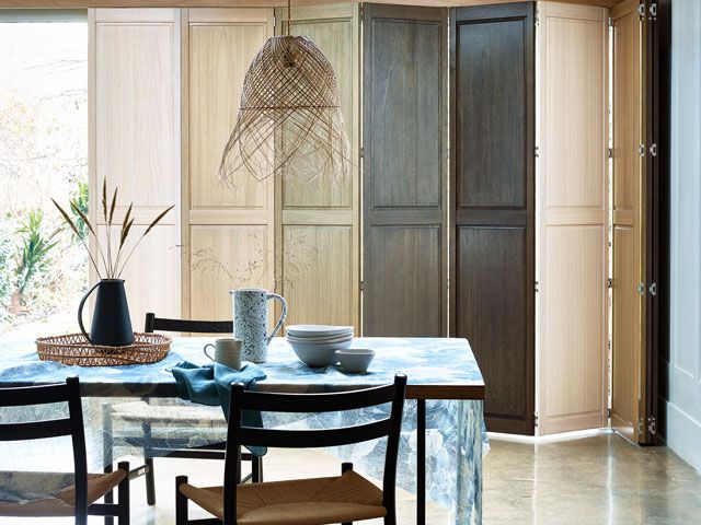 tracked ombre wood shutters in a bohemian style dining room by Hillarys