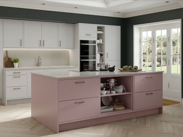A grey painted kitchen with white units and a pink kitchen island -masterclass-kitchens-kitchens-goodhomesmagazine.com