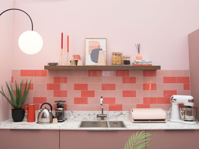 living coral kitchen with subway tiles and a marble worktop with classic appliances in the Good Homes roomsets at Ideal Home Show 2019