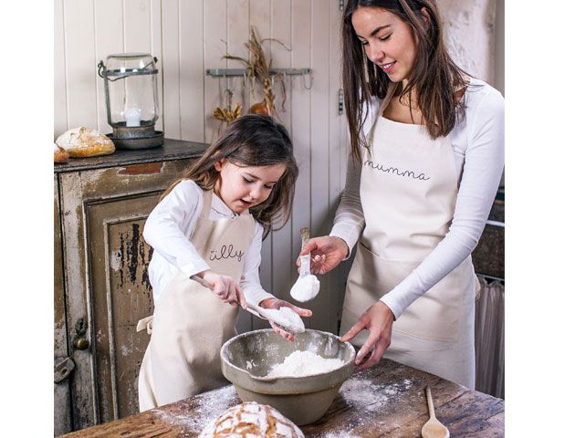 Mother and daughter wearing personalised aprons whilst baking -notonhighstreet-living-room-goodhomesmagazine.com
