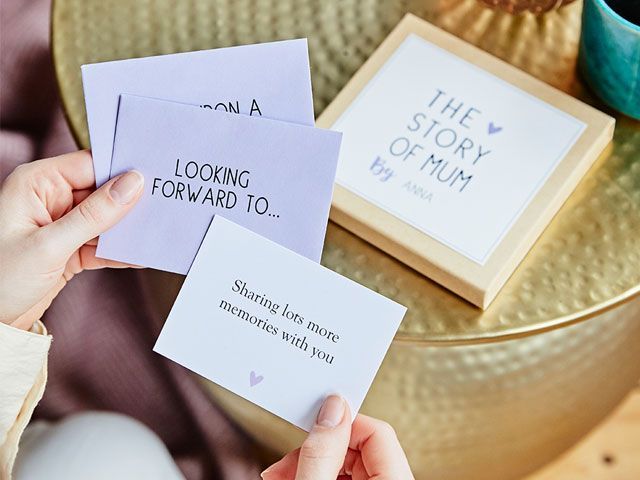 Woman holding letters from a personalised Mother's Day messages gift box designed by Martha Brook for NotontheHighStreet -living-room-goodhomesmagazine.com