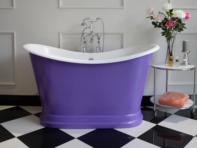 purple tubby torre duo by albion baths in a bathroom with a black and white floor