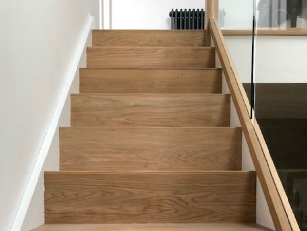 wooden stairs with glass balustrade