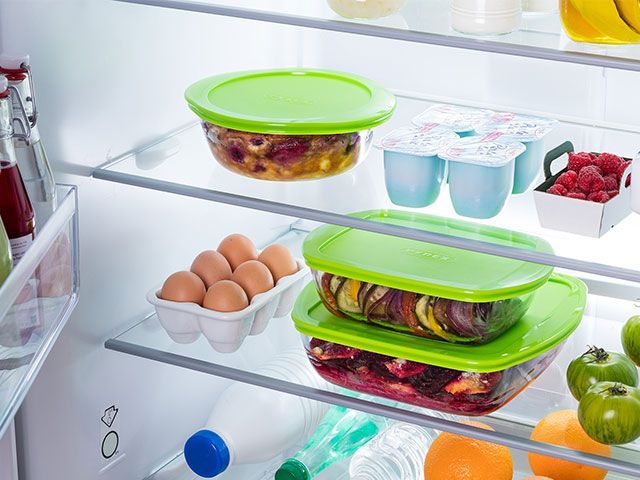 Pyrex Cook and Store BPA-free food storage with green lids, stacked inside a fridge