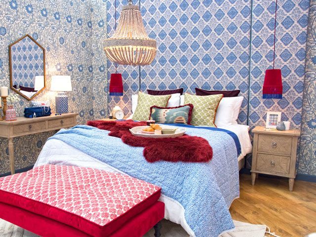 blue decorative headboard in a traditional bedroom designed for the Queen at good homes roomsets at Ideal Home Show 2019