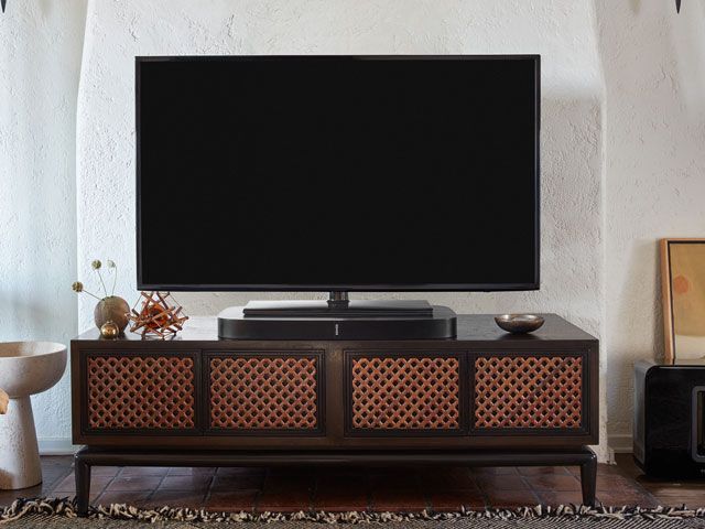Sonos playbase sitting under TV in a living room 