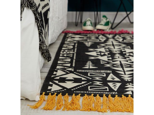 asos supply black and white abstract printed rug with red and yellow fringing