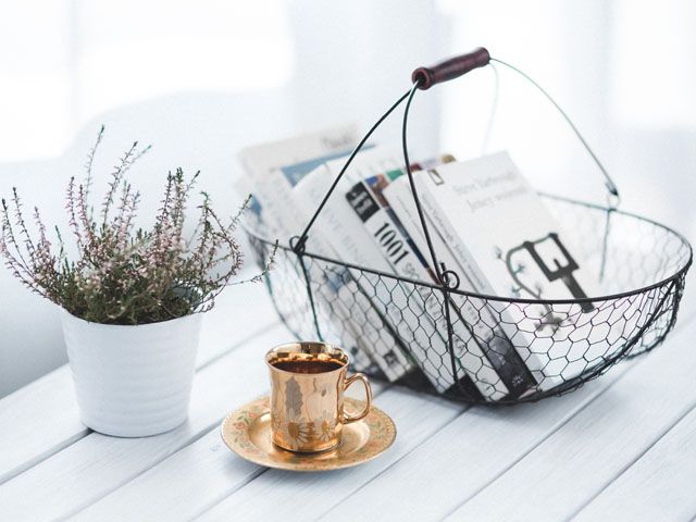 basket, book on a white table with a lavender plant and gold cup and saucer, kaboompics, 5 new interior design books to fire your creativity