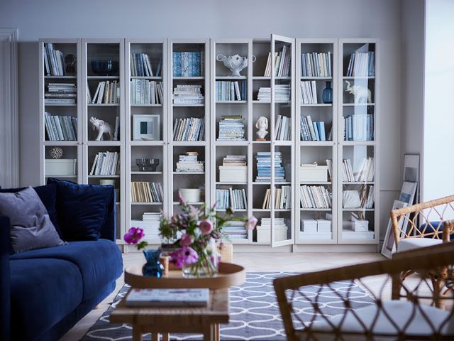 ikea billy bookcase in white in a real home living room with sofa, coffee table and wicker chairs