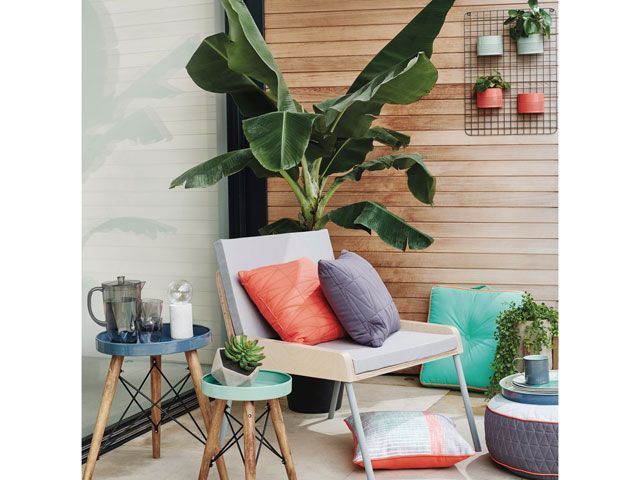 outdoor chair with cushions and tropical plants from Sainsbury's Home SS19 collection 