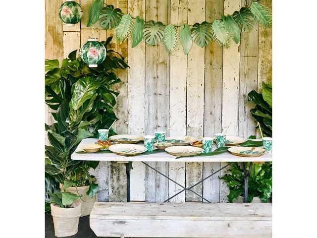 wood table and wall with tropical palm prints decorations by Talking Tables