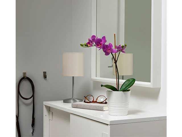 lilac orchid in white vase on white side cabinet - best artificial flowers - IKEA - goodhomesmagazine.com.jpg