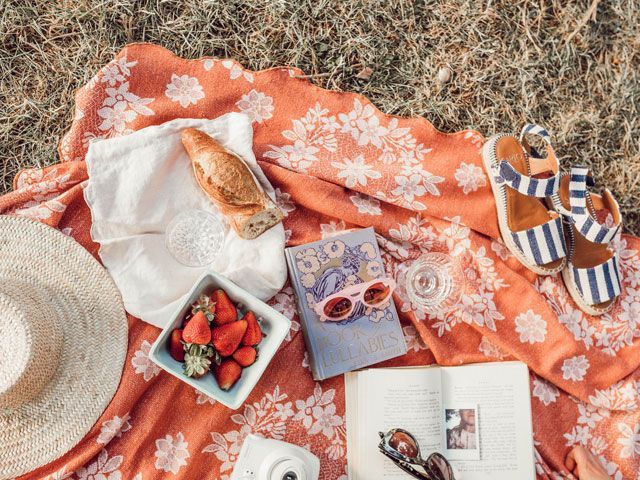 picnic blanket with sandals, sunhat, bread in the summer