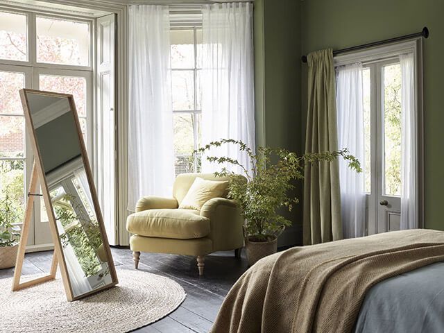 light green velvet heavy curtains layered with soft white sheers in bedroom - curtain ideas - goodhomesmagazine.com
