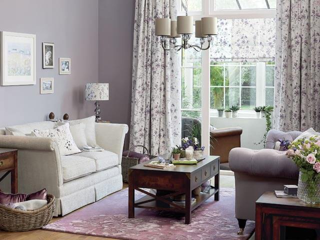 purple floral curtains sitting wide over windows - curtain ideas - Laura Ashley - goodhomesmagazine.com