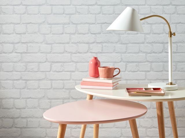 Accessorize Camden Brick Wallpaper in Light Grey with pink and white nest of tables and various pink accessories