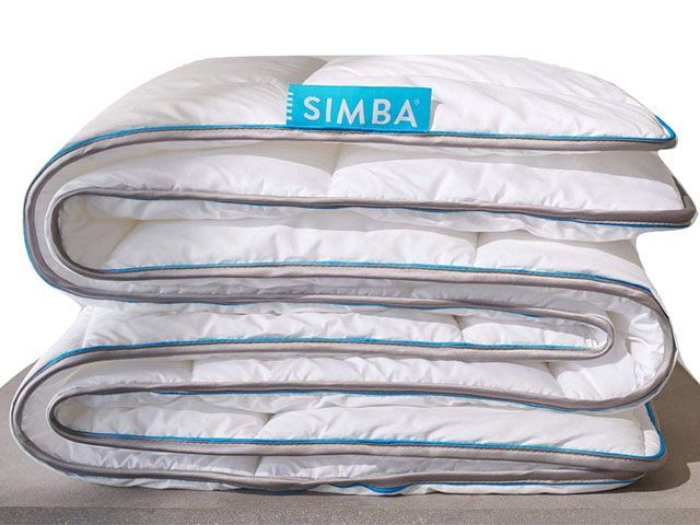 Folded king size white summer duvet with blue piping