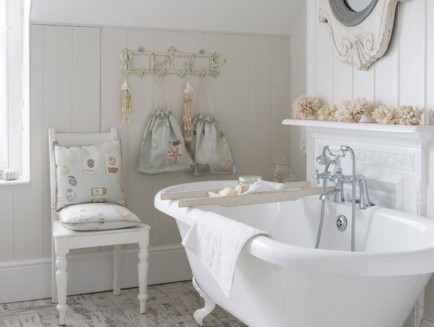 nautical themed white washed bathroom with shells - goodhomesmagazine.com