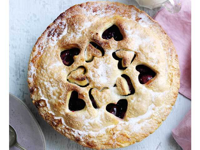 cherry and bay leaf pie with cut out hearts on top on table - Love Fresh Cherries - goodhomesmagazine.com