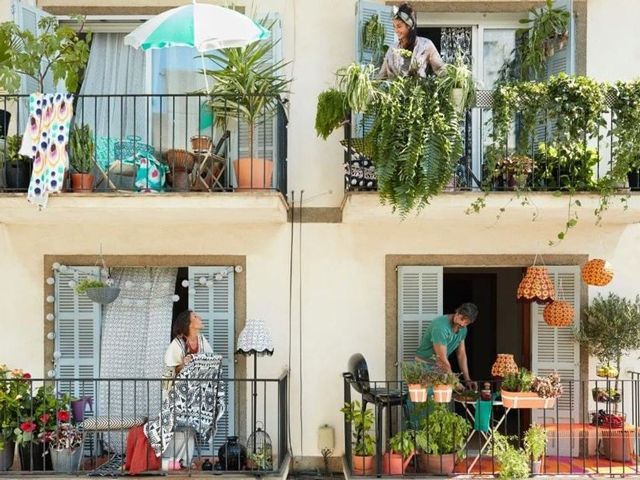 owners of ikea boklok flatpack tiny homes on their balconies with plants