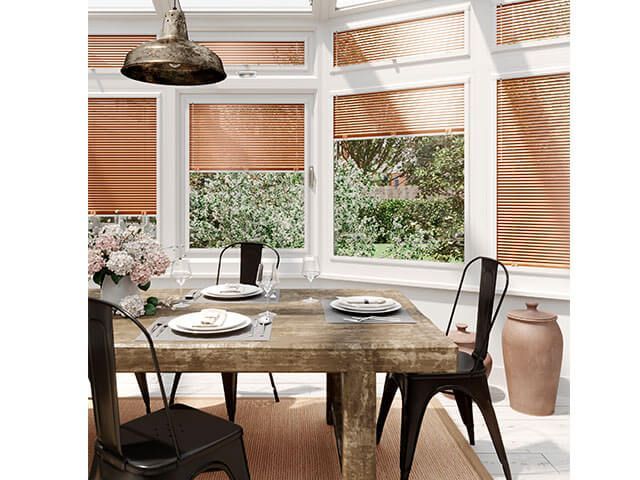 conservatory with worn table metal chairs metal lamp copper blinds - conservatory decor ideas - goodhomesmagazine.com