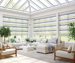 how to keep a conservatory cool: large white conservatory with window blinds, white floor tiles and light furniture