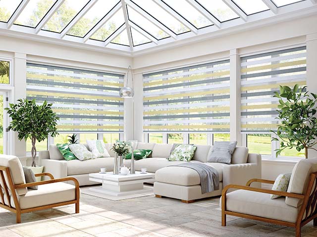 how to keep a conservatory cool: large white conservatory with window blinds, white floor tiles and light furniture