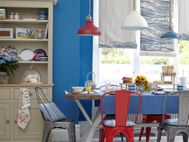 nautical themed dining room with bold blue walls, rope, classic dresser - goodhomesmagazine.com