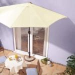 semi-parasol against building over garden furniture - wayfair - best parasol - goodhomesmagazine.com