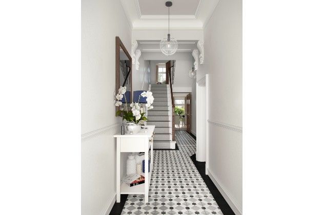 A hallway decorated with geometric floor tiles
