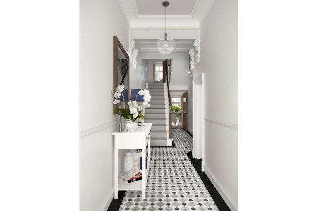 A hallway decorated with geometric floor tiles