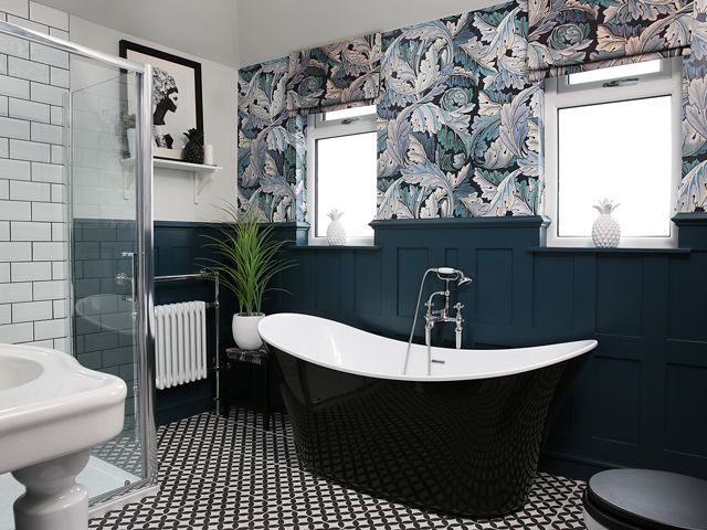 after the bathroom makeover featuring tropical wallpaper and a black and white roll top bath