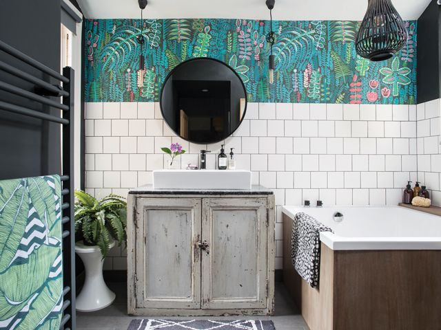 after the bathroom makeover with tropical, distressed wood, bright wallpaper and industrial lighting