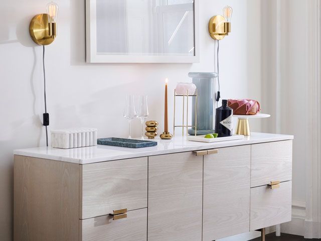 west elm sideboard and sconce lights in a dining room