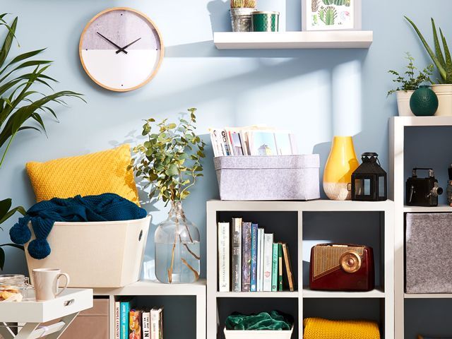 wilko storage boxes, shelving and clock in a compact living room