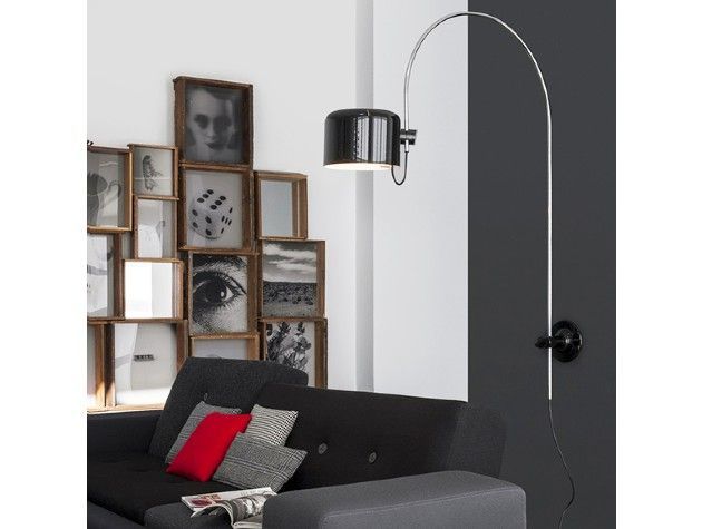A wall mounted arc lamp above a sofa